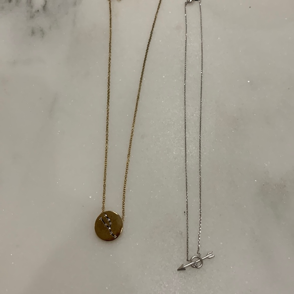 Zodiac necklace in gold tone and arrow necklace‎ in silver tone.